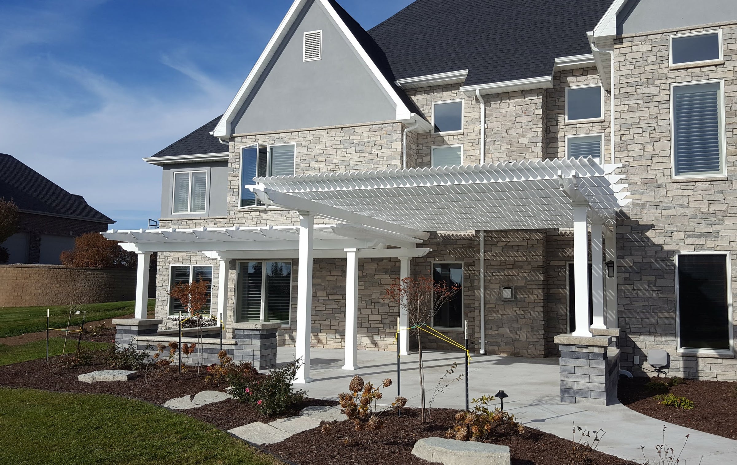 Picture of a custom-sized pergola providing shade to the entrance of a home