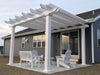 Picture of a traditional-style white vinyl pergola with overhangs covering a backyard cement patio off the home