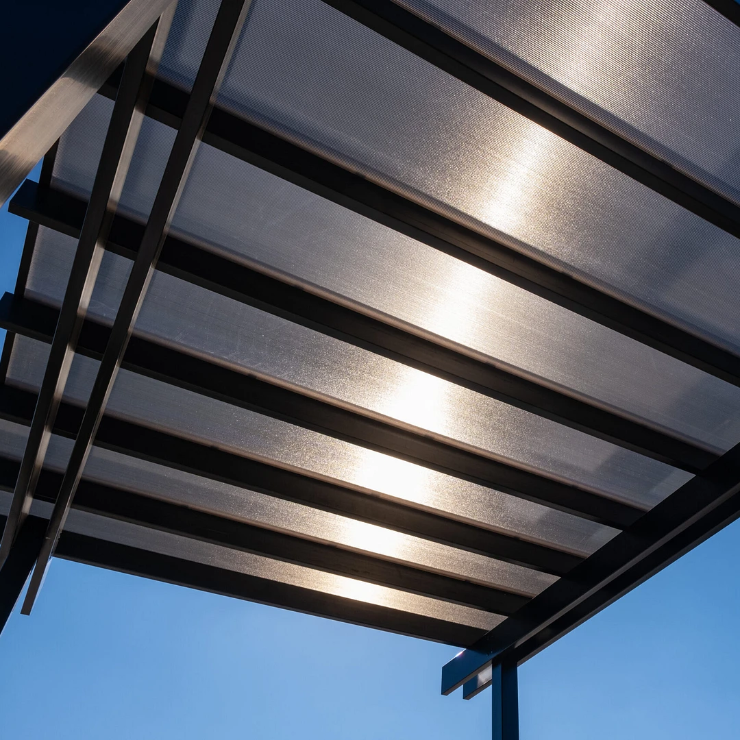 Freestanding pergola with a solid roof providing covered outdoor living space