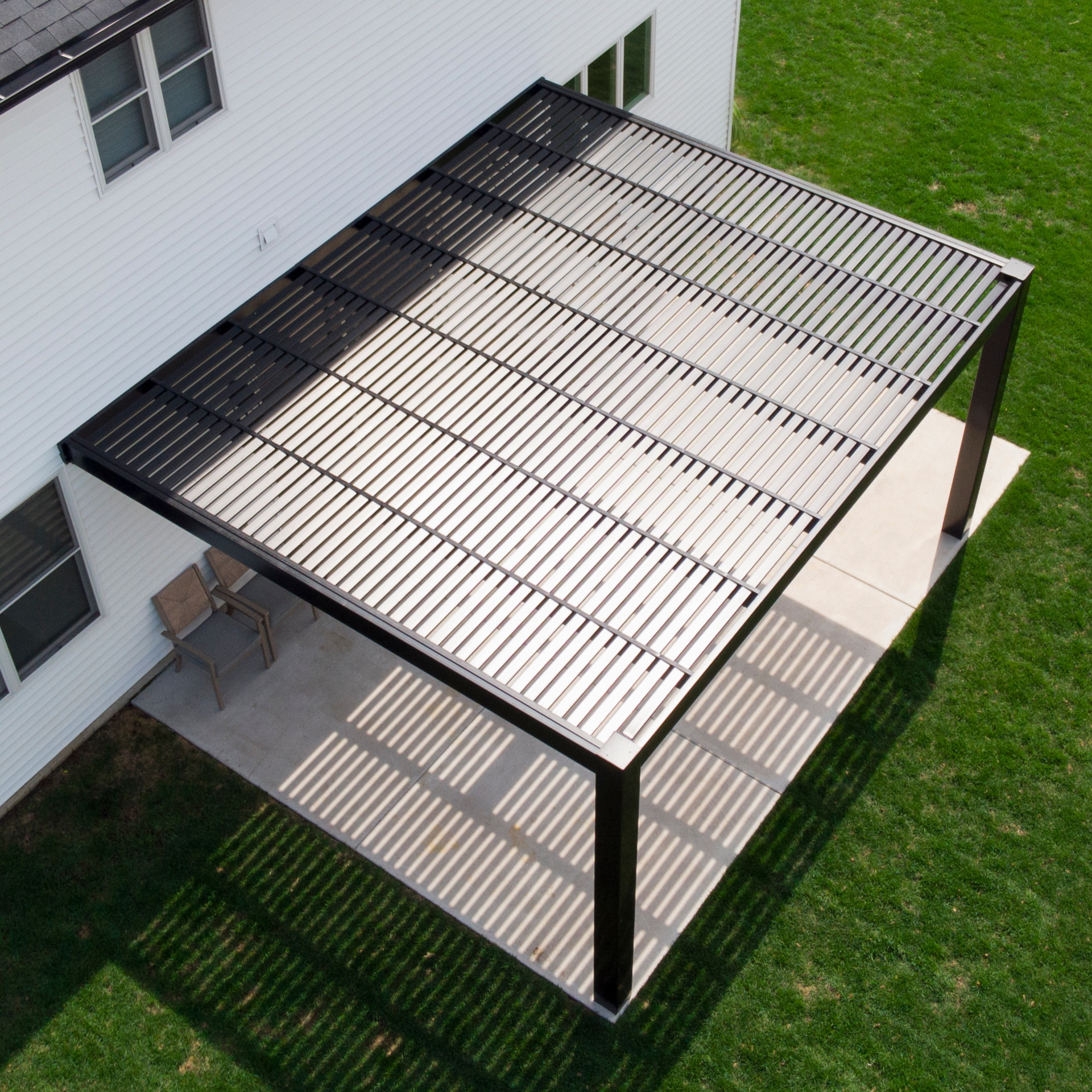 Attached modern vinyl pergola with flush corners and fixed roof slats
