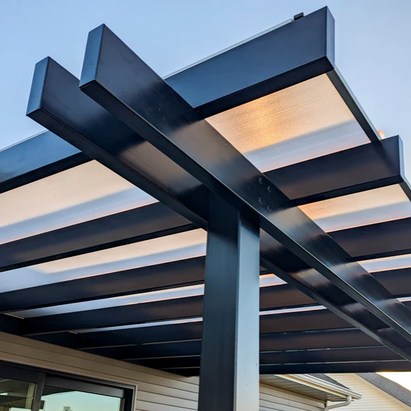 Close-up view of the top corner of a patio cover with beams extending about a foot past the edge of the Polycarbonate roof