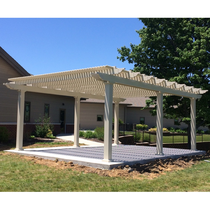 Picture of a tan vinyl free-standing traditional pergola with overhangs in the back yard of a home, with a dining table and chairs underneath the pergola