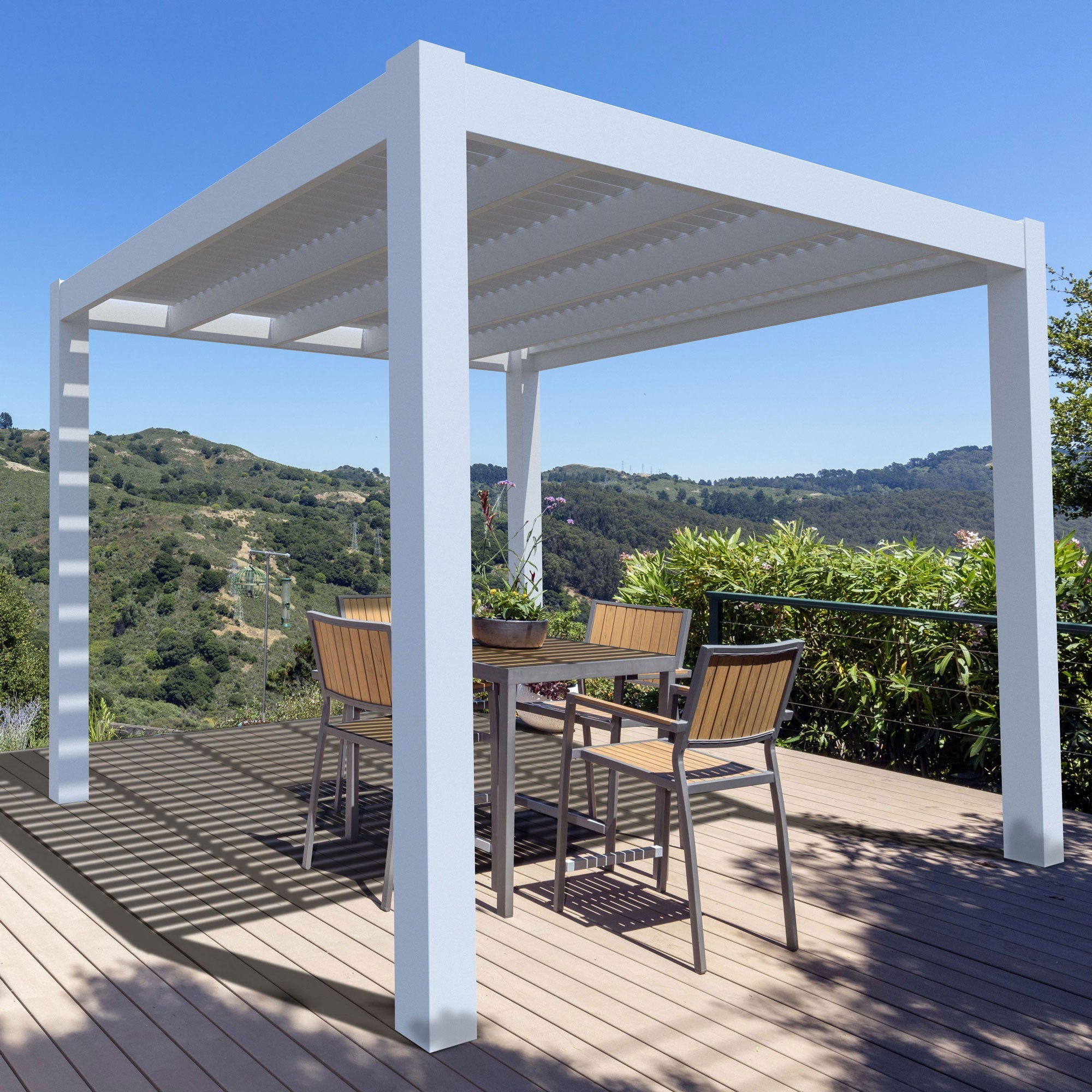 Modern free-standing white vinyl pergola on a tan deck overlooking a beautiful mountain landscape