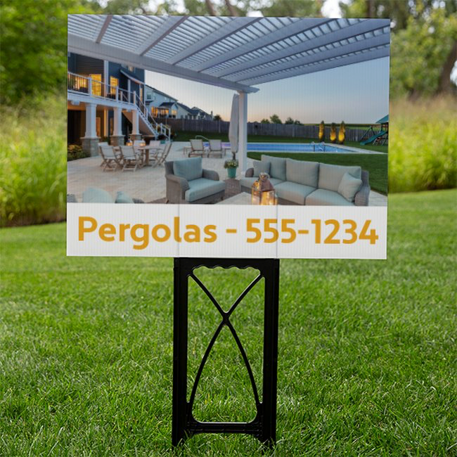 Close-up picture of a yard sign featuring the picture of a white traditional 4-post pergola from underneath the pergola with a dummy phone number