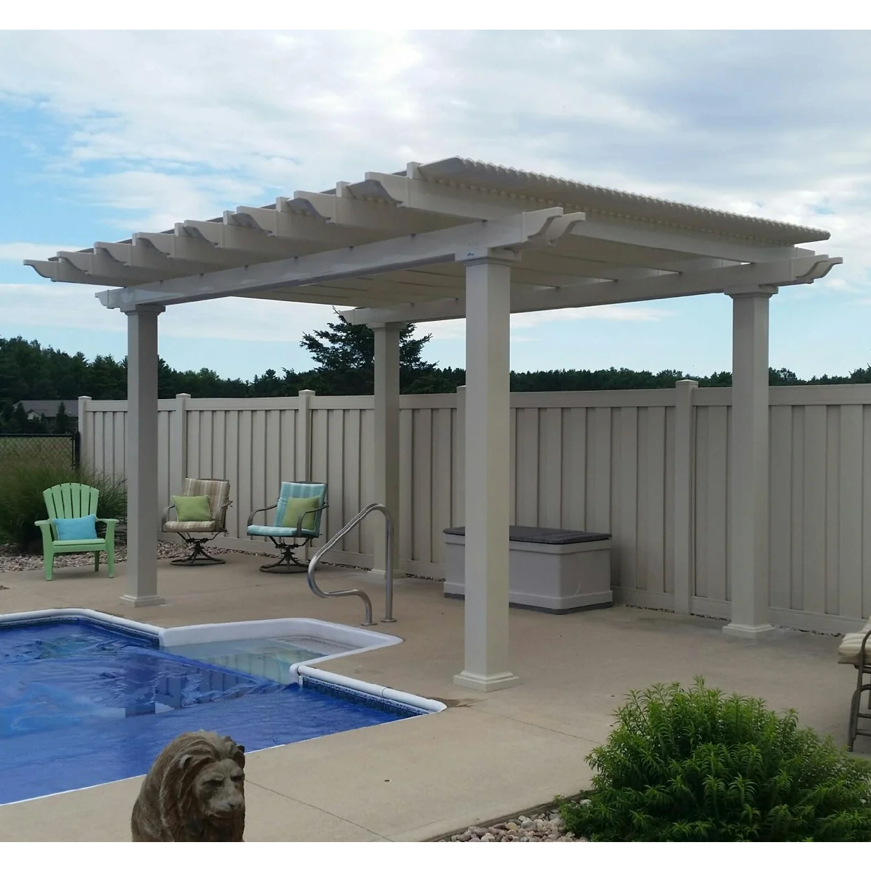 Picture of a tan 4-post traditional pergola providing shade next to a backyard pool
