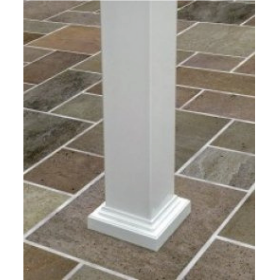 Close-up view of the bottom of a white square pergola post (column) with a nice trim ring on the bottom