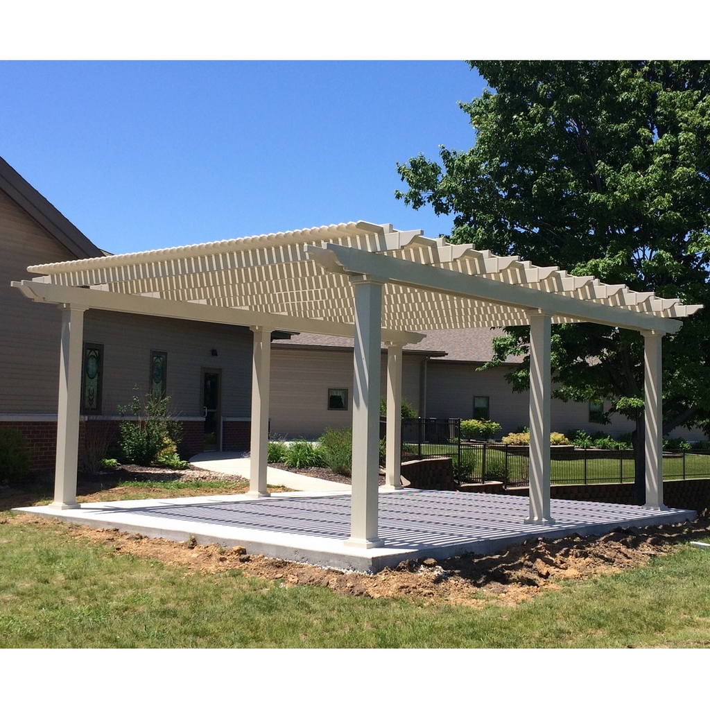 Sandstone tan traditional 6-post pergola with overhangs providing shade for a concrete pad near a couple of buildings